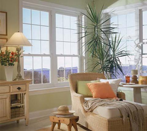 Traditional Family Room with light tan wicker lounge chairs