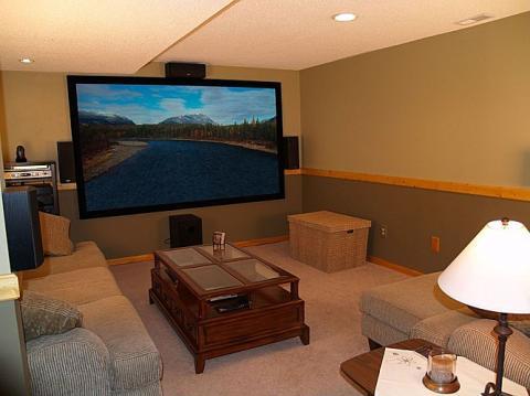 Traditional Home Theater with dark wood and glass coffee table