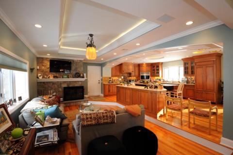 Contemporary Family Room with medium wood stained cabinets