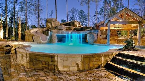 Eclectic Pool with cut stone pool surround