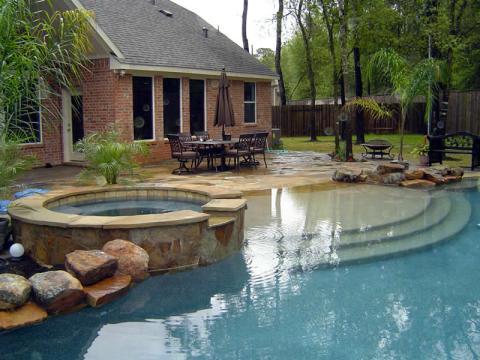 Transitional Pool with hot tub connected to pool