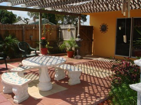 Eclectic Patio with stone patio table and bench seats