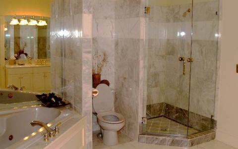 Traditional Master Bathroom with clear glass shower door