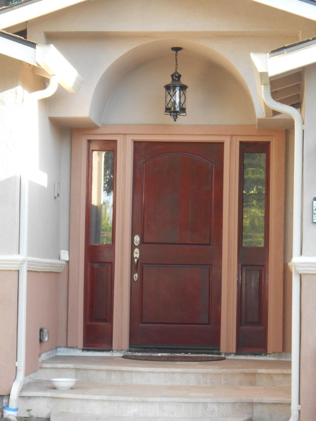Tuscan Patio with stained wood front door