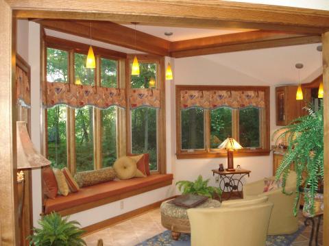 Eclectic Sunroom with upholstered round ottoman