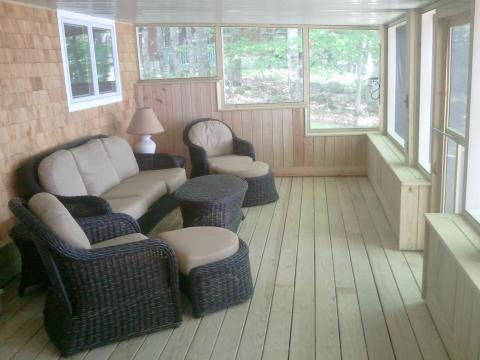 Contemporary Sunroom with black wicker cushioned seating
