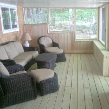 Contemporary Sunroom with black wicker cushioned seating