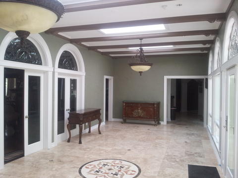 Transitional Sunroom with large french doors with arch