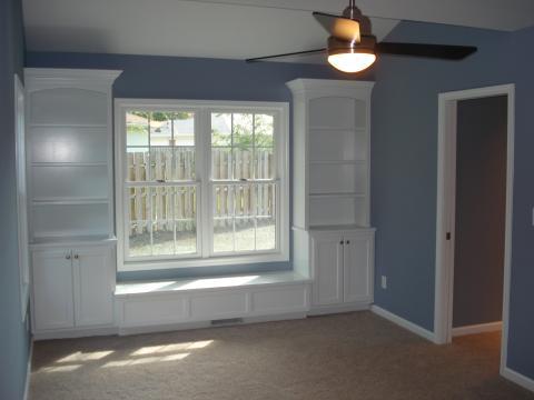 Traditional Bedroom with custom book shelves and window seat