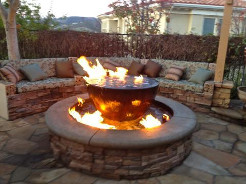 Transitional Patio with round above ground fire pit
