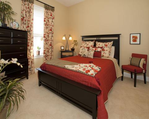 Traditional Bedroom with dark wood bedside dresser