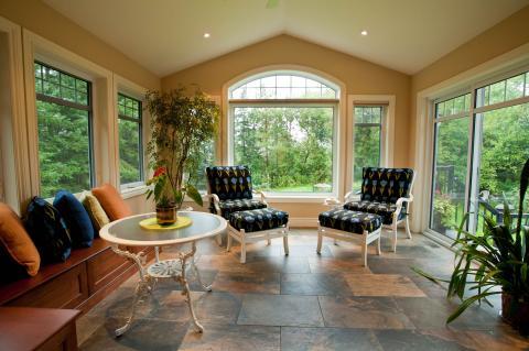 Traditional Sunroom with white framed windows and doors