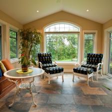 Traditional Sunroom with white framed windows and doors