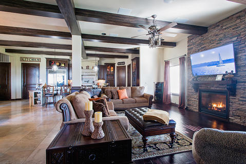 Traditional Family Room with beige stacked stone faced fireplace