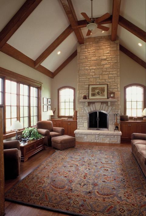Traditional Family Room with light brown suede sofa and arm chair with ottoman