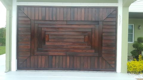 Eclectic Garage with wood work on garage door