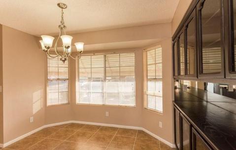 Transitional Dining Room with brushed nickel chandelier