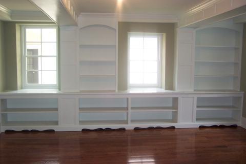 Transitional Library with white built in bookcases