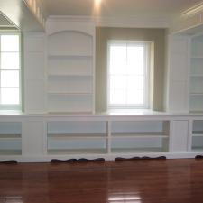 Transitional Library with white built in bookcases