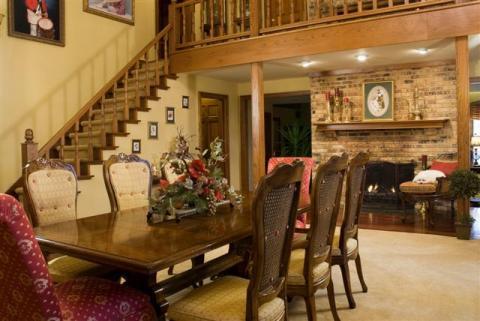 Traditional Dining Room with red upholstered chair