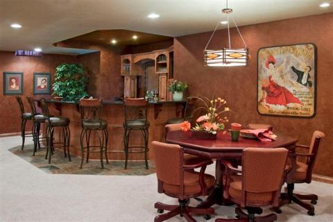 Traditional Basement with red upholstered armchairs on rollers