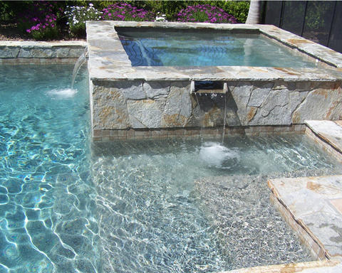 Traditional Pool with flower bed with dark mulch