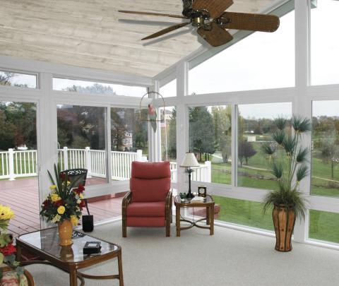 Traditional Sunroom with dark wood coffee table with glass top