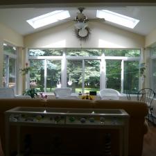 Transitional Sunroom with black metal side table and chair