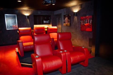 Modern Home Theater with red leather chairs