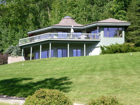 Mid-Century Modern Home Exterior with wrap-around deck and railing