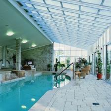Transitional Sunroom with light tan wicker patio furniture