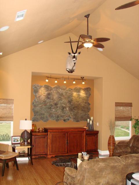 Eclectic Family Room with wicker style arm chair and ottoman with black legs