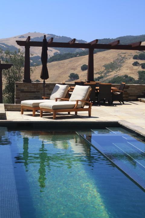 Contemporary Pool with dark wood trellis over wall