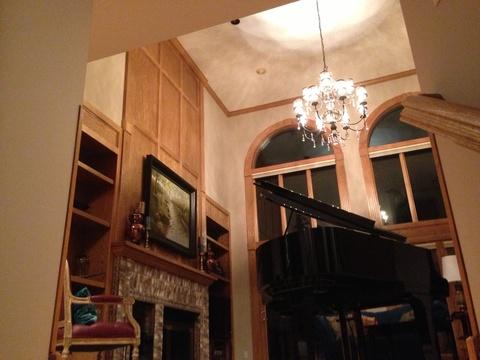 French Library with wood paneling and mantle