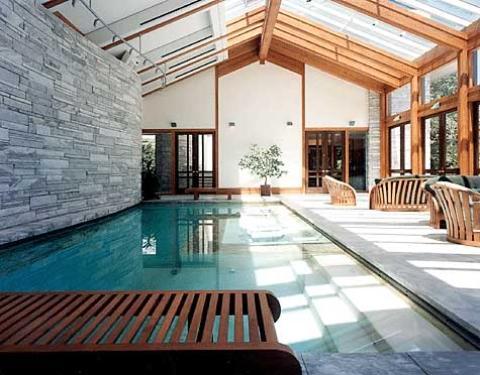 Transitional Pool with light wood framed windows and doors