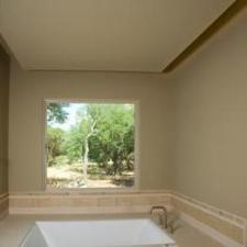 Transitional Master Bathroom with large window over tub