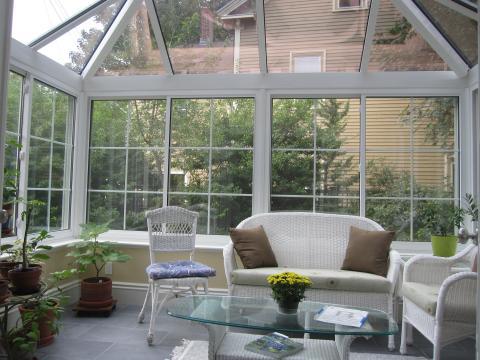 Traditional Sunroom with white framed windows and doors