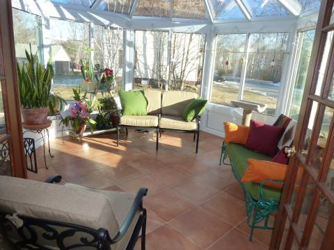 Transitional Sunroom with turquoise painted metal patio bench