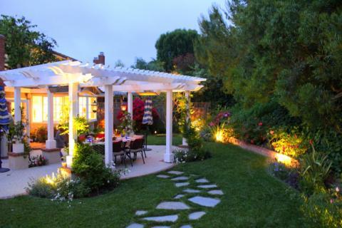 Cottage Patio with light design between landscape
