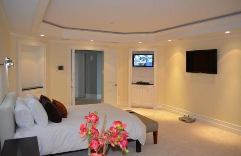 Transitional Bedroom with custom wall niche with cabinets