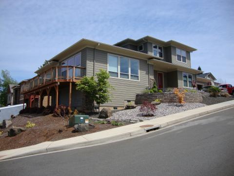 Contemporary Home Exterior with large home on sloped landscape