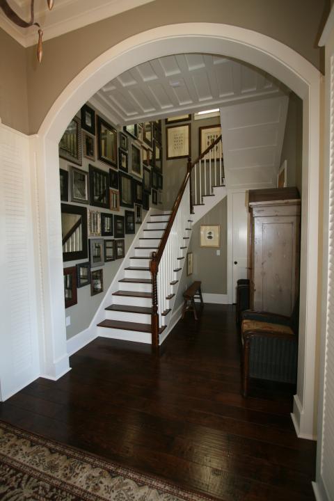 Traditional Entry with many framed mirror all place on one wall