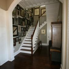 Traditional Entry with many framed mirror all place on one wall