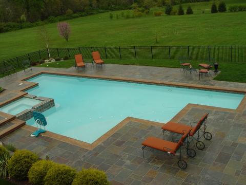 Traditional Pool with large grass field in backyard