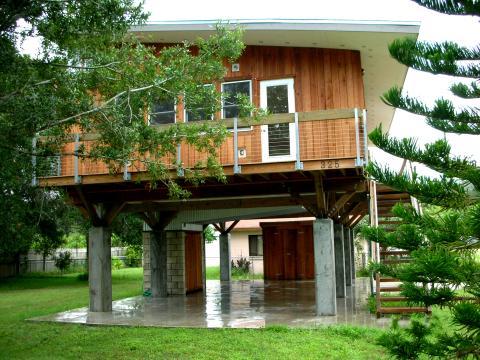 Modern Home Exterior with columns holding up home above patio