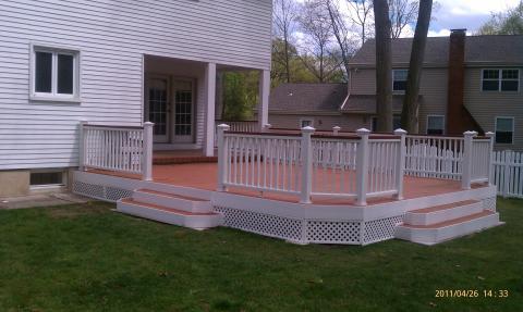 Traditional Deck with white lattice fence under deck