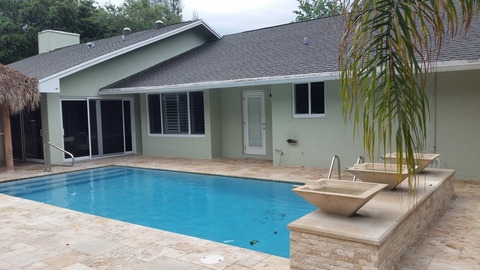 Contemporary Pool with architectural composition roof