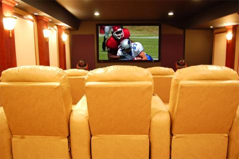 Traditional Home Theater with dark cherry wood wall column details