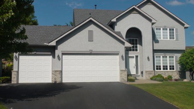 Transitional Home Exterior In Hutchinson Three Car Garage Asphalt Transitional Home Exterior With Asphalt Paved Driveway