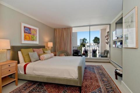 Transitional Bedroom with red and blue area rug